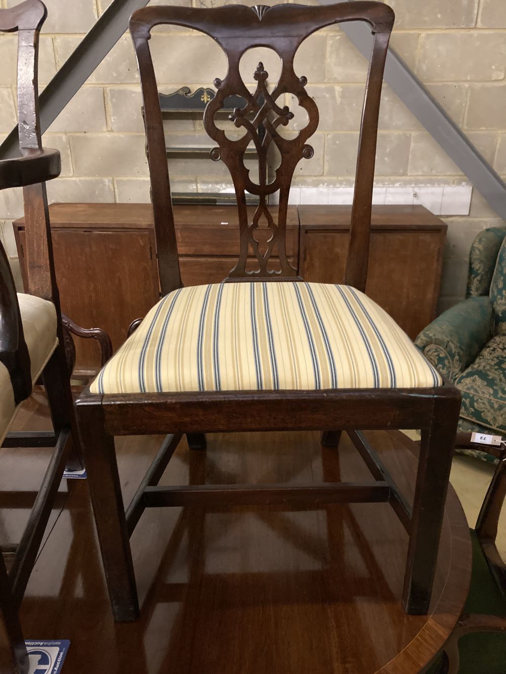 Two George III mahogany elbow chairs and a single chair
